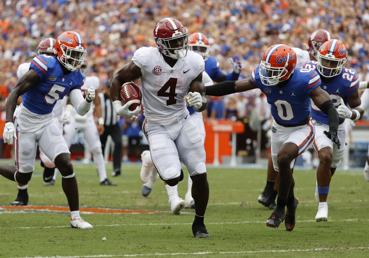 Alabama running back Brian Robinson Jr. (4) runs with the ball as Florida safety Trey Dean III (0) defends. Mandatory Credit: Kim Klement-USA TODAY 
